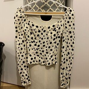 Black and white spotted reformation blouse